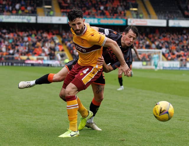 'Well defender Ricki Lamie jostles with Marc McNulty