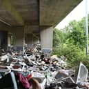 Baths, asbestos, washing machines and bin bags piled up under the M8 motorway last year. Picture: John Devlin