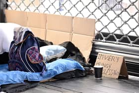 Rough sleepers lay in a makeshift bed  (Photo by JUSTIN TALLIS/AFP via Getty Images)