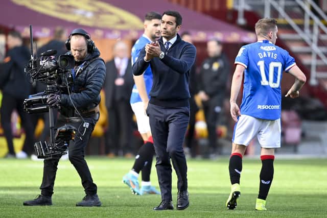 Rangers manager Giovanni van Bronckhorst takes the acclaim of the Rangers fans at full time.