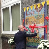 Joe McCaig from East Renfrewshire Council unveils the mosaic