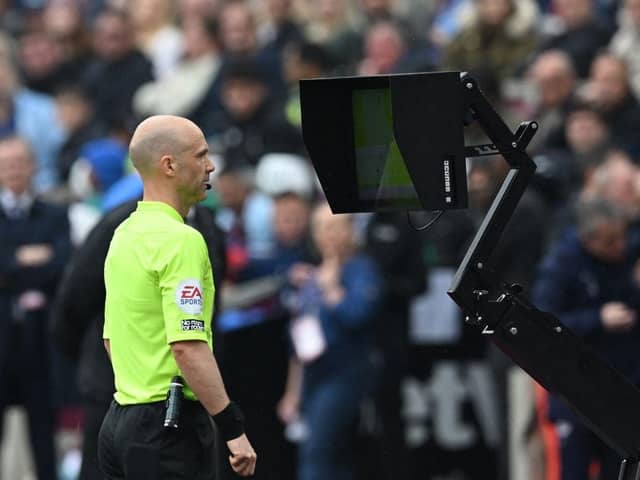 Referee Anthony Taylor looks at the VAR screen during a Premier League match between West Ham United and Manchester City. (Photo by JUSTIN TALLIS/AFP via Getty Images)