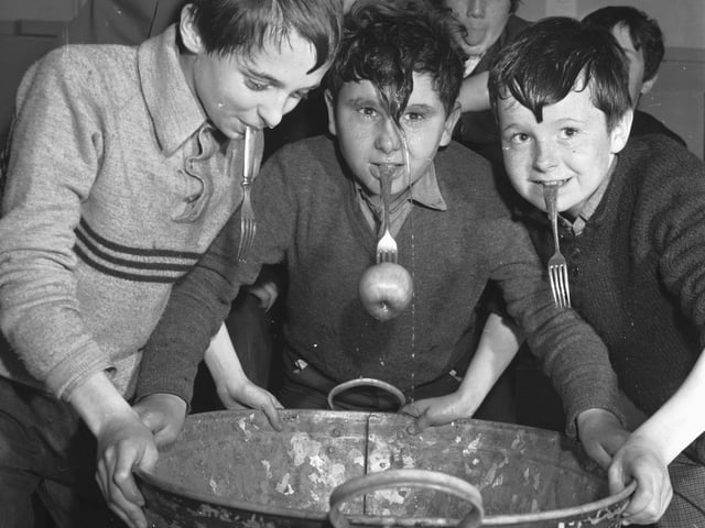 Dooking for apples was another Halloween tradition, made easier by dropping forks into the bucket of apples (which were floating in water).