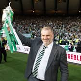 Ange Postecoglou celebrates in front of the Celtic supporters with the Scottish Cup.