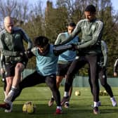 Aaron Mooy and Moritz Jenz with Reo Hatate during a Celtic training session.