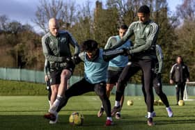 Aaron Mooy and Moritz Jenz with Reo Hatate during a Celtic training session.