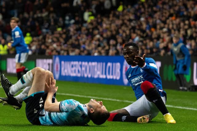 Dundee's Ryan Sweeney reacts after a clash with Rangers winger Fashion Sakala during the Premier Sports Cup quarter-final at Ibrox.  (Photo by Paul Devlin / SNS Group)