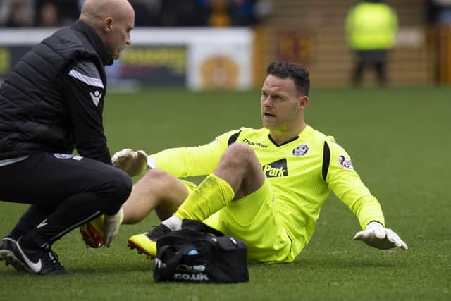 Trevor Carson being treated for a previous injury while playing against Hearts in 2018. Photo: Graeme Hunter