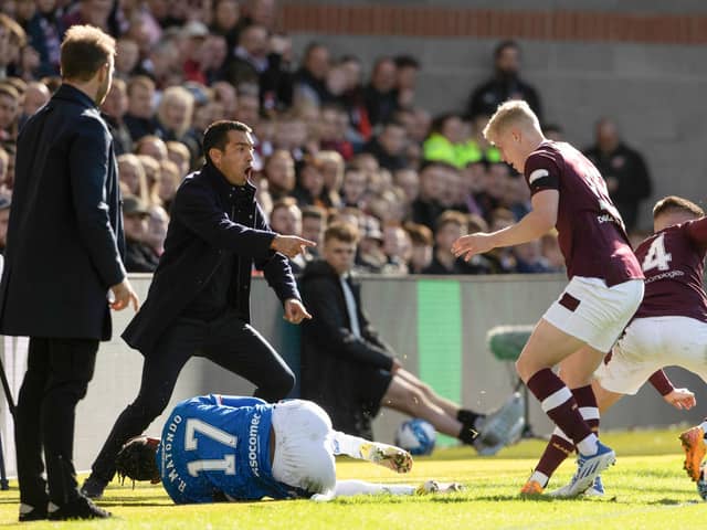 Rangers manager Giovanni van Bronckhorst complains about Hearts midfielder Cammy Devlin's tackle on Rabbi Matondo.