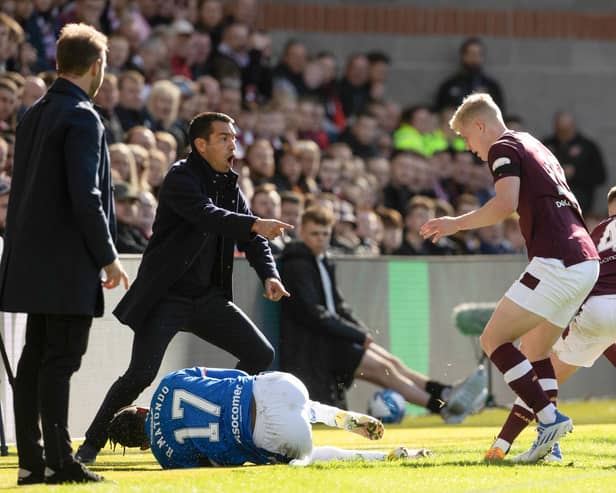 Rangers manager Giovanni van Bronckhorst complains about Hearts midfielder Cammy Devlin's tackle on Rabbi Matondo.