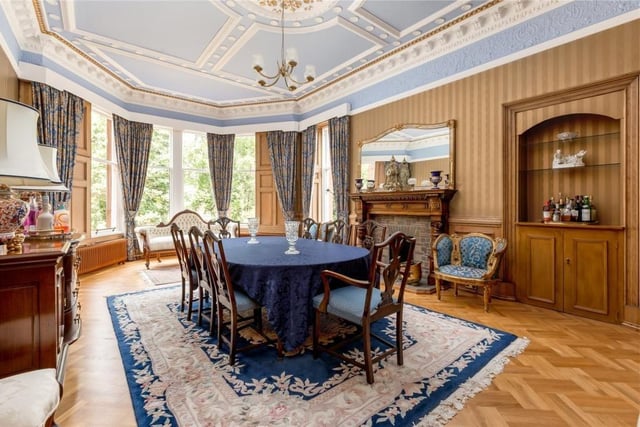 The dining room has parquet flooring and intricate cornice work.