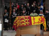 King Charles III and members of his family look on as the Duke of Hamilton places the Crown of Scotland on Queen Elizabeth II's coffin. Picture: Aaron Chown/WPA Pool/Getty