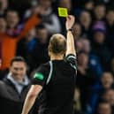 Willie Collum gives Ayr manager Scott Brown a yellow card during the Scottish Cup clash with Rangers.