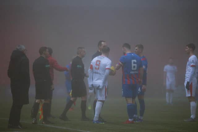 Referee Barry Cook explains his decision to Clyde skipper David Goodwillie and Airdrie captain Callum Fordyce (pic: Craig Black Photography)