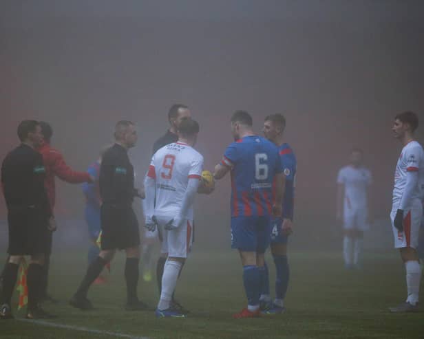 Referee Barry Cook explains his decision to Clyde skipper David Goodwillie and Airdrie captain Callum Fordyce (pic: Craig Black Photography)