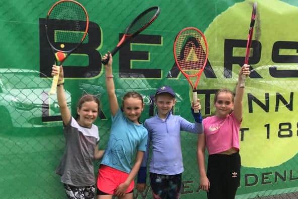 We love tennis! More young enthusiasts from Bearsden LTC hold their rackets aloft