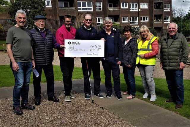 Colin Robertson is pictured in the centre of the photo between local RNIB Scotland volunteer Derek Goodwin (left) and club president Stuart Sharkie, who was presented the cheque along with other club members.