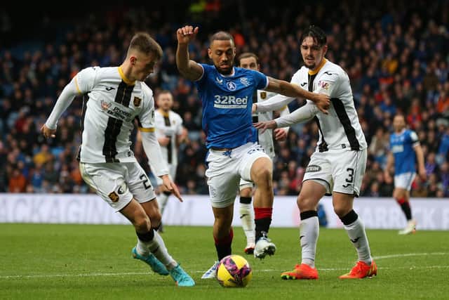 Rangers' Kemar Roofe (centre) tries to find a way through the Livingston defence.
