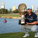 Ewen Ferguson celebrates with his trophy after the final round of the Commercial Bank Qatar Masters. Pic by Stuart Franklin/Getty Images