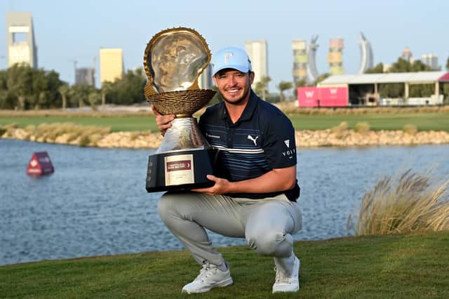 Ewen Ferguson celebrates with his trophy after the final round of the Commercial Bank Qatar Masters. Pic by Stuart Franklin/Getty Images