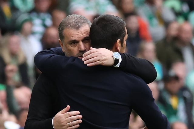 Rangers manager Giovanni van Bronckhorst and Celtic manager Ange Postecoglou embrace after the game.
