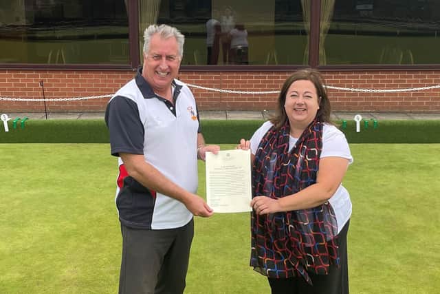 Kirsten Oswald MP presents Giffnock Bowling Club president Andy Burt with a printed copy of her Early Day Motion - Lawn bowling clubs in East Renfrewshire