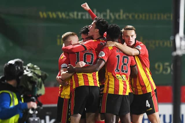 Partick Thistle's players celebrate a fine win.