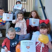 The winners of the online decorated ball competition last year assembled on the Tolbooth steps with their certificates.