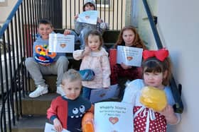 The winners of the online decorated ball competition last year assembled on the Tolbooth steps with their certificates.