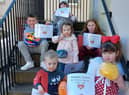 The winners of the online decorated ball competition last year assembled on the Tolbooth steps with their certificates.