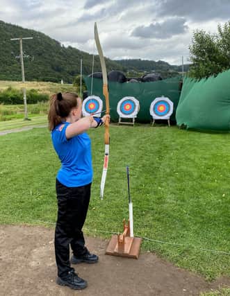 YPSP member Molly Sands is trying out archery.