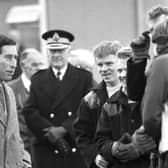 Prince Charles chats with workmen during a visit to the Easterhouse market garden project in Glasgow, December 1987.