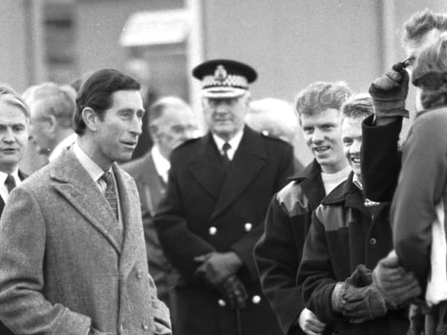 Prince Charles chats with workmen during a visit to the Easterhouse market garden project in Glasgow, December 1987.