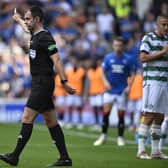 Referee Don Robertson awards the foul on Celtic's Gustaf Lagerbielke and rules out Kemar Roofe's Rangers goal after consulting the VAR monitor. (Photo by Rob Casey / SNS Group)