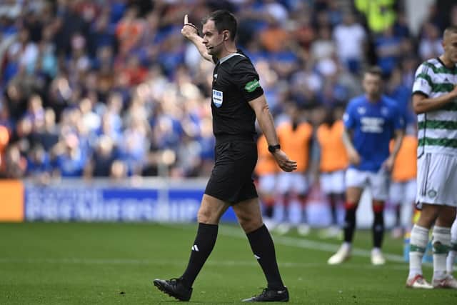 Referee Don Robertson awards the foul on Celtic's Gustaf Lagerbielke and rules out Kemar Roofe's Rangers goal after consulting the VAR monitor. (Photo by Rob Casey / SNS Group)