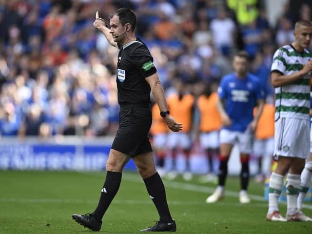 Referee Don Robertson awards the foul on Celtic's Gustaf Lagerbielke and rules out Kemar Roofe's Rangers goal after consulting the VAR monitor. (Photo by Rob Casey / SNS Group)