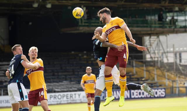 Ricki Lamie wins a header for the Steelmen, for whom new Finnish defender Juhani Ojala is also pictured
