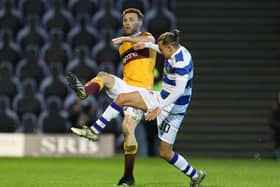 Stephen O'Donnell battles with Morton's Aidan Nesbitt on Friday night (Pic by Ian McFadyen)