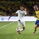 Eder Militao of Real Madrid controls the ball under pressure from Oli McBurnie.