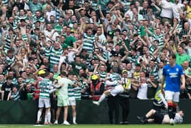 Celtic's players celebrate with fans after the big win over Rangers.