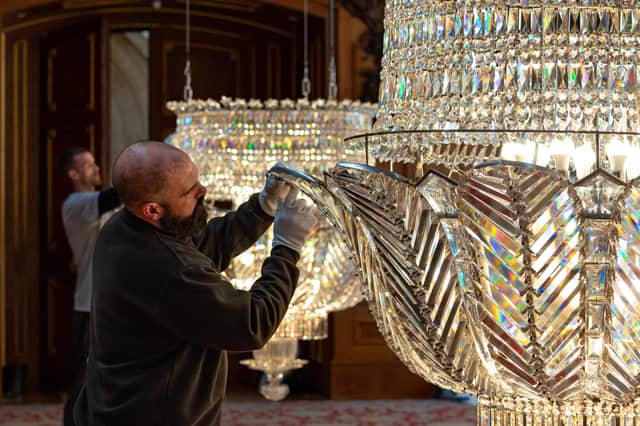 Gloves are worn to protect the chandeliers from the effects of skin oils.