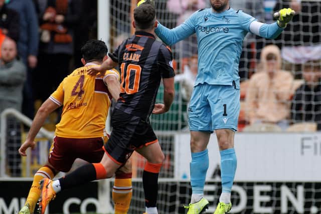 Motherwell keeper Liam Kelly heads clear