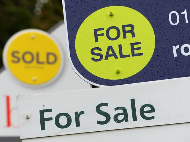 General view of estate agents signs outside a block of flats in Basingstoke, Hampshire.