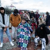 Earthquake survivors sit around a fire in Iskenderun Turkey