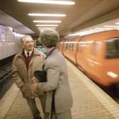 A couple chatting in Buchanan Street underground station in Glasgow as the train comes in, August 1990.