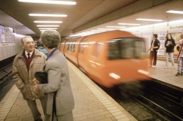 A couple chatting in Buchanan Street underground station in Glasgow as the train comes in, August 1990.