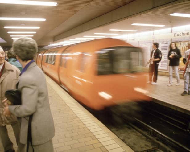 A couple chatting in Buchanan Street underground station in Glasgow as the train comes in, August 1990.