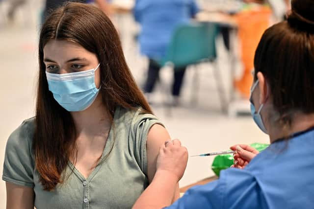 Teenager Katie Moore receives a covid-19 vaccine at a vaccination centre in Barrhead, south of Glasgow on August 9, 2021. Photo by JEFF J MITCHELL/POOL/AFP via Getty Images