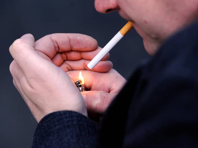 PICTURE POSED MY MODEL: A general view of a man smoking a cigarette.