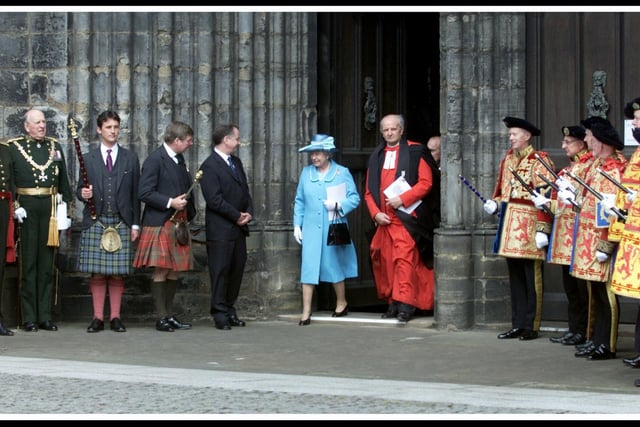 HRH The Queen, with the Minister of Glasgow Cathedral, the Very Reverend Dr William Morris,  leaves Glasgow Cathedral, to meet the First Minister, Jack McConnell (centre left) and other members of the  Royal Procession, following the Thanksgiving Service on the Queen's Golden Jubilee in 2002.